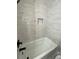 Updated bathroom with white subway tile and a bathtub at 5730 Hoover Ave, Hanahan, SC 29410