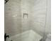 Modern bathroom with white subway tile and a bathtub at 5730 Hoover Ave, Hanahan, SC 29410