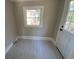 Bright laundry room with light grey vinyl flooring and white door at 5730 Hoover Ave, Hanahan, SC 29410