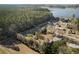 Aerial view of neighborhood near water, showing homes and wooded areas at 601 Levee Dr, Moncks Corner, SC 29461