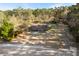Aerial view of a house and surrounding land, wooded area, and a body of water at 601 Levee Dr, Moncks Corner, SC 29461