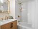 Updated bathroom with white tile, a bathtub, and gold fixtures at 613 Pompano St, Edisto Island, SC 29438