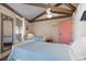 Bedroom with twin beds, light blue bedding and a full-length mirror at 613 Pompano St, Edisto Island, SC 29438