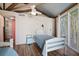 Light and airy bedroom with twin beds and access to a private deck at 613 Pompano St, Edisto Island, SC 29438
