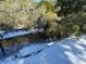 Small creek partially frozen over with snow on ground at 613 Pompano St, Edisto Island, SC 29438