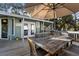 Deck with outdoor dining set and umbrella at 613 Pompano St, Edisto Island, SC 29438