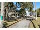 Beach cottage view from driveway, surrounded by palm trees at 613 Pompano St, Edisto Island, SC 29438