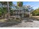 Two-story home with wrap-around deck and stairs at 613 Pompano St, Edisto Island, SC 29438
