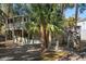 Two-story home with wrap-around deck and stairs at 613 Pompano St, Edisto Island, SC 29438