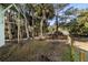 Fenced backyard with tropical landscaping and privacy at 613 Pompano St, Edisto Island, SC 29438