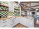 White kitchen with wood countertops and green checkered backsplash at 613 Pompano St, Edisto Island, SC 29438