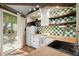 White kitchen with stainless steel appliances and green tile backsplash at 613 Pompano St, Edisto Island, SC 29438