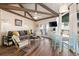 Bright living room features hardwood floors, comfy seating, and access to a deck at 613 Pompano St, Edisto Island, SC 29438
