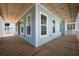 Spacious porch with wood floors and tongue and groove ceiling, perfect for outdoor entertaining at 6522 Beagle Club Rd, Meggett, SC 29449
