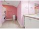 Pink bathroom with shower, toilet and pedestal sink at 7003 Old Landing Dr, Hanahan, SC 29410