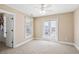 Spacious bedroom with carpet, a ceiling fan, and access to a balcony at 7003 Old Landing Dr, Hanahan, SC 29410