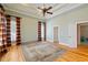 Bright bedroom with hardwood floors, plantation shutters, and a ceiling fan at 7003 Old Landing Dr, Hanahan, SC 29410