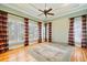 Spacious bedroom with hardwood floors, plantation shutters, and a ceiling fan at 7003 Old Landing Dr, Hanahan, SC 29410