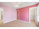 Bedroom with pink walls, carpet, and walk-in closet at 7003 Old Landing Dr, Hanahan, SC 29410