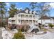 Stunning two-story home with a charming front porch and brick accents at 7003 Old Landing Dr, Hanahan, SC 29410