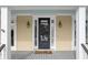 Elegant black front door with sidelights and a welcoming porch at 7003 Old Landing Dr, Hanahan, SC 29410