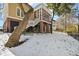 Backyard view of charming two-story home with screened porch and snowy landscape at 7003 Old Landing Dr, Hanahan, SC 29410