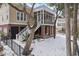 Two-story house with screened porch, brick accents, and snowy yard at 7003 Old Landing Dr, Hanahan, SC 29410