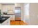 Bright kitchen boasts stainless steel refrigerator and hardwood floors at 7003 Old Landing Dr, Hanahan, SC 29410