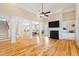 Open living room with hardwood floors and views into the kitchen at 7003 Old Landing Dr, Hanahan, SC 29410