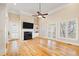 Bright living room features hardwood floors, fireplace, and built-in shelving at 7003 Old Landing Dr, Hanahan, SC 29410