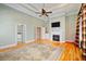 Large main bedroom with hardwood floors, fireplace, and access to bathroom at 7003 Old Landing Dr, Hanahan, SC 29410