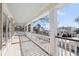 Large covered porch overlooking the neighborhood, featuring white columns and railings at 7003 Old Landing Dr, Hanahan, SC 29410