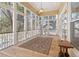 Relaxing screened porch with wood flooring and ceiling fan at 7003 Old Landing Dr, Hanahan, SC 29410