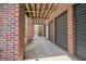Brick walkway leading to covered storage area with multiple doors at 7003 Old Landing Dr, Hanahan, SC 29410