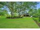 Landscaped backyard with large oak trees and lush lawn at 975 Mayfield St, Summerville, SC 29485
