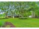 Large backyard with a view of the house and surrounding trees at 975 Mayfield St, Summerville, SC 29485