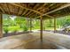 Under house patio area with concrete floor and lush landscaping view at 975 Mayfield St, Summerville, SC 29485