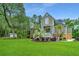 Two story home with a large front yard, palm trees, and American flag at 975 Mayfield St, Summerville, SC 29485