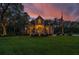 Two-story home with large windows, a spacious deck, and a landscaped yard at 975 Mayfield St, Summerville, SC 29485