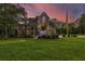 Two-story home with large windows, a spacious deck, and a landscaped yard at 975 Mayfield St, Summerville, SC 29485