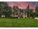 Two-story home with large windows, a spacious deck, and a landscaped yard at 975 Mayfield St, Summerville, SC 29485