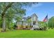 Two story home with a large front yard, palm trees, and American flag at 975 Mayfield St, Summerville, SC 29485