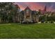 Two-story home with large windows, a spacious deck, and a landscaped yard at 975 Mayfield St, Summerville, SC 29485