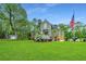 Two story home with a long driveway, green lawn and shed at 975 Mayfield St, Summerville, SC 29485