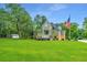 Two story home with a long driveway, green lawn and shed at 975 Mayfield St, Summerville, SC 29485