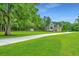 Landscaped lawn with large oak trees and a home in the background at 975 Mayfield St, Summerville, SC 29485