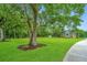 Landscaped lawn with large oak trees and a home in the background at 975 Mayfield St, Summerville, SC 29485