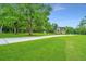 Landscaped lawn with large oak trees and a home in the background at 975 Mayfield St, Summerville, SC 29485