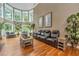 Relaxing living room with hardwood floors, leather seating, and abundant natural light at 975 Mayfield St, Summerville, SC 29485