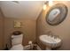 Convenient powder room with pedestal sink and decorative mirror at 975 Mayfield St, Summerville, SC 29485